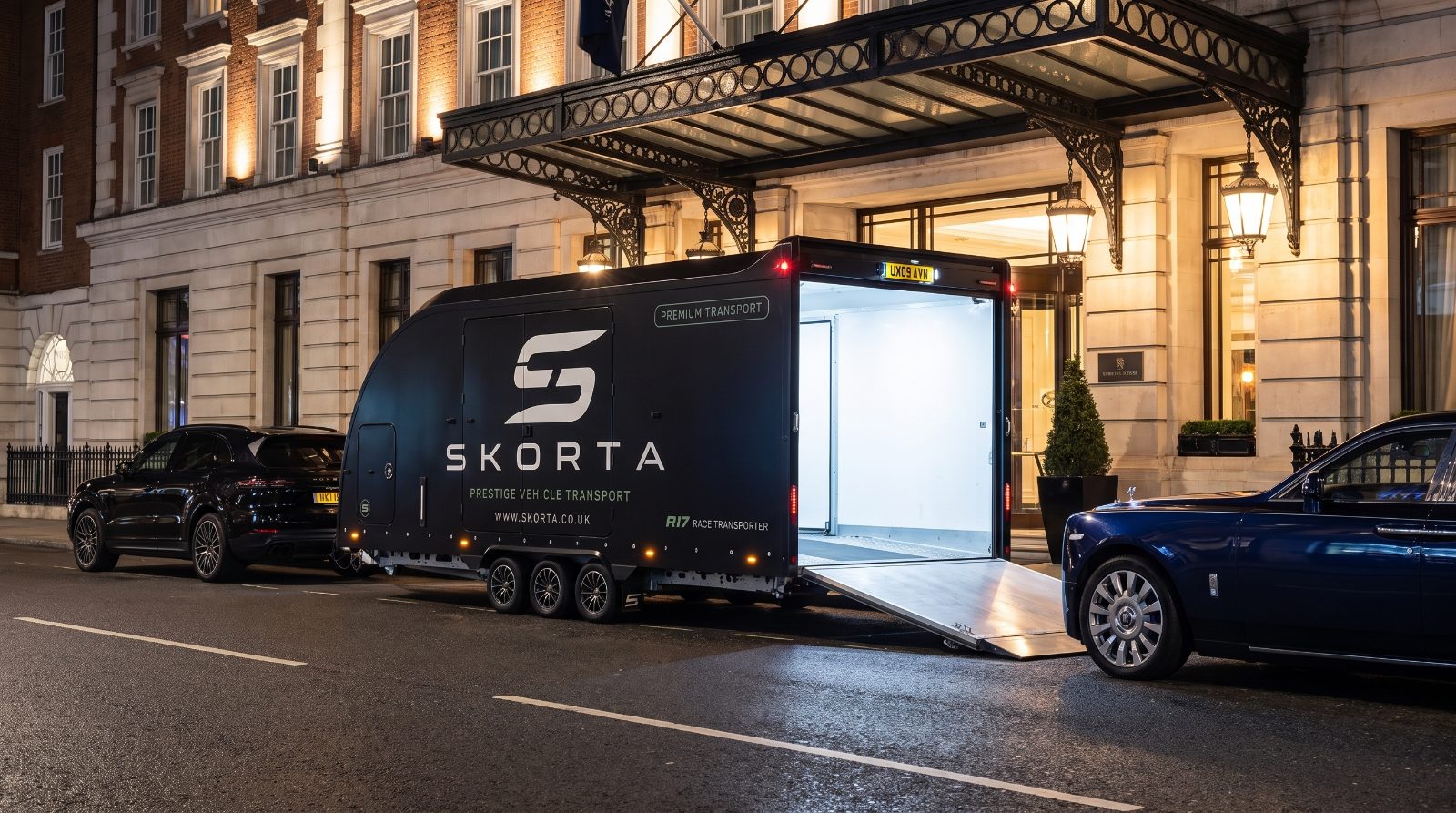 A Rolls-Royce Phantom beside the open SKORTA trailer outside a Mayfair hotel at night